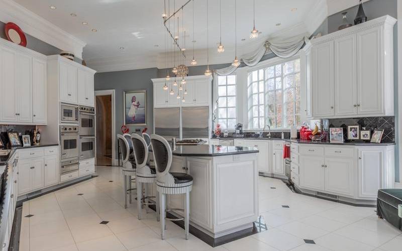 Incredible chefs kitchen with beautiful appliance package, marble floors and an eating area beyond belief.