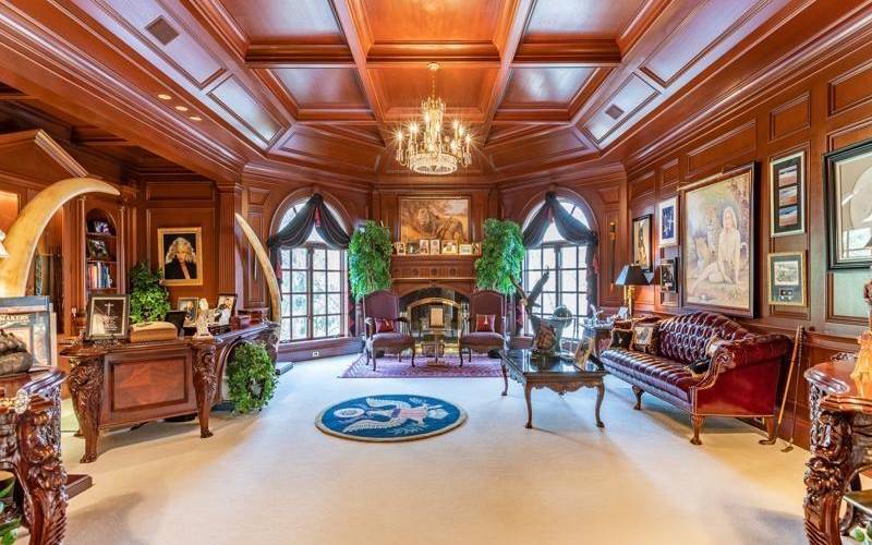 This office will blow your mind. It has exquisite woodwork, fireplace, and a hidden bathroom.